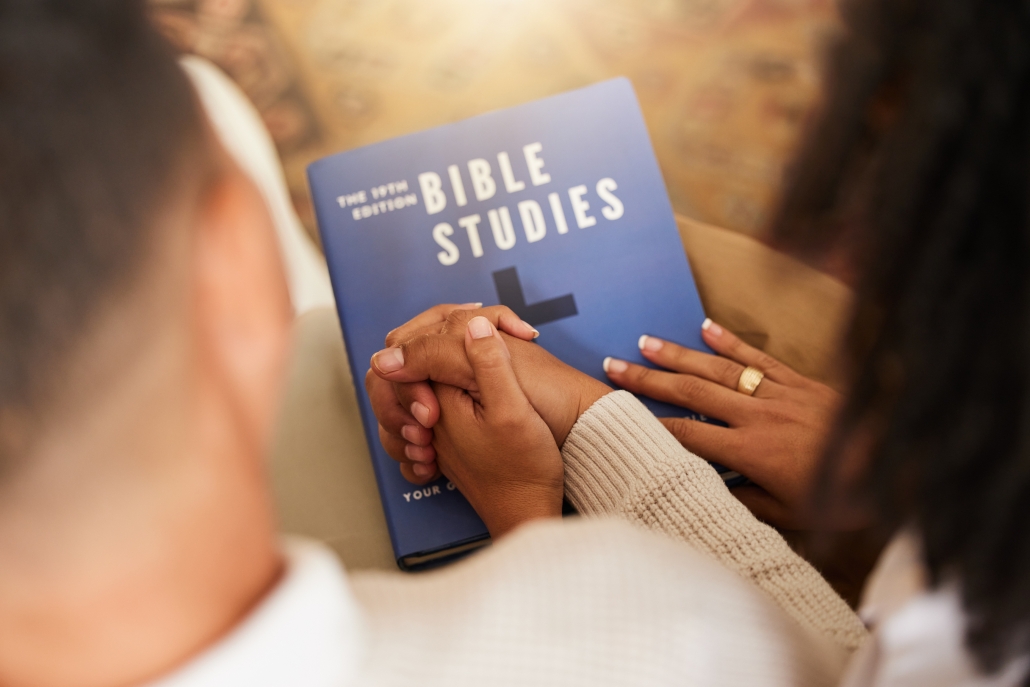 religion-studying-couple-holding-hands-with-bible-worship-prayer-trust-relationship-love-care-man-woman-with-affection-while-learning-about-god-faith-christianity